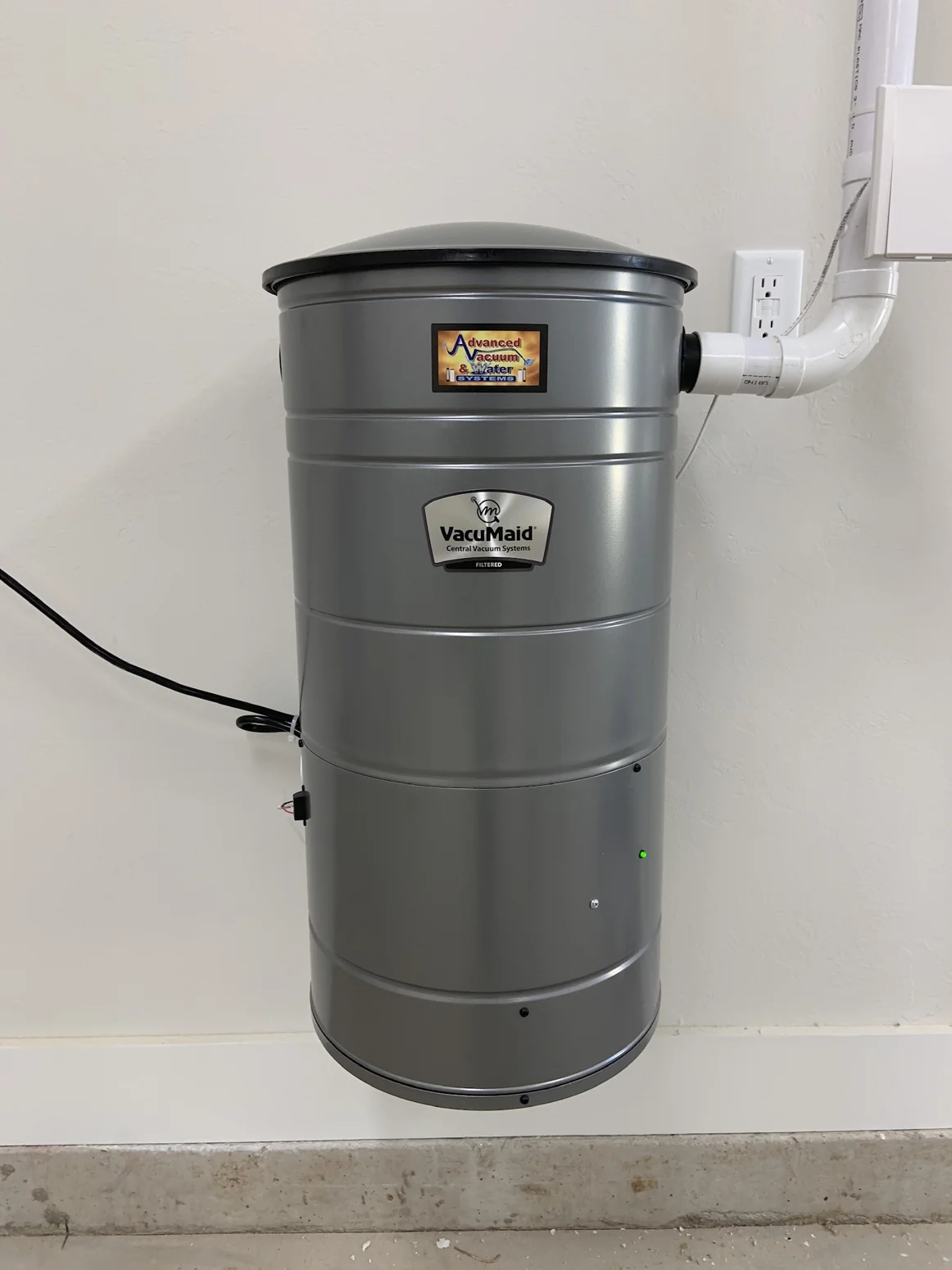 Real professionally installed silver VacuMaid central vacuum power unit